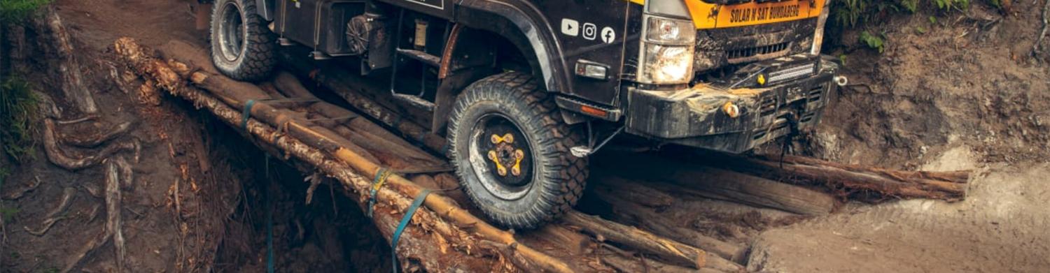 atw expedition truck crossing logs